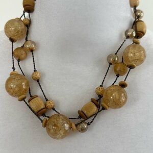Vintage Signed Dabby Reid 3 strand beaded necklace Various tan colors. 18”
